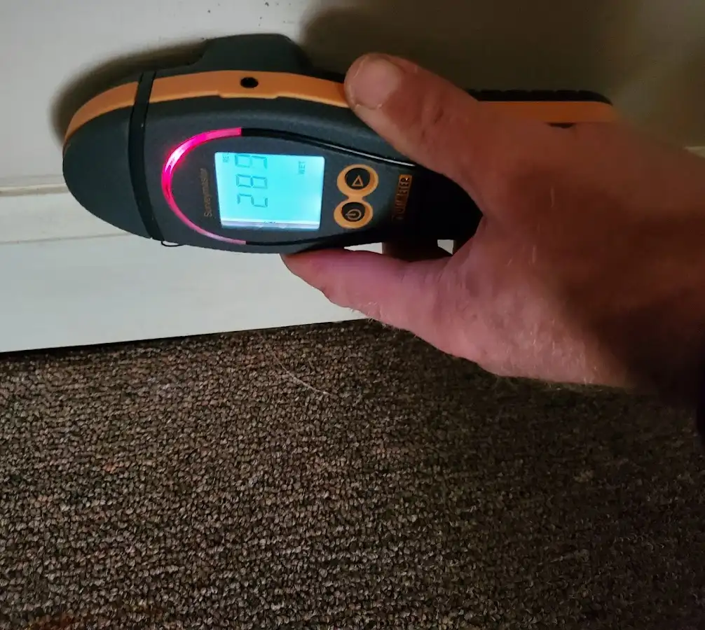 Moisture detection at baseboard during Storm Damage Restoration in Flower Mound